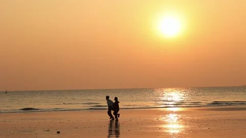A couple running together during sunset Stock Footage 235653360