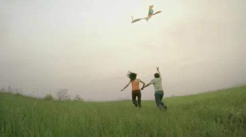 Couple runs with kite Stock Footage 38073927
