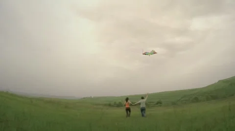 Couple runs with kite Stock Footage 38076191