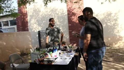 Couple sampling cannabis products at fair Stock Footage 154561904