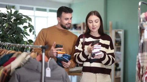 Couple scans QR code and label of socks in shop Stock Footage 328142607