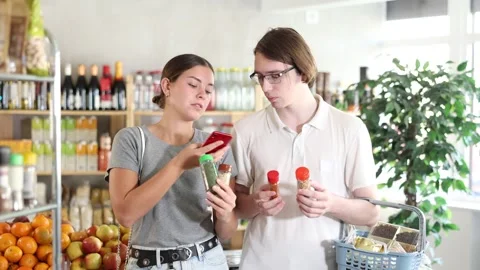 Couple scans the QR code on the spices and seasonings, reads information about Video stock 318945953