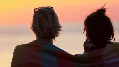 A couple by the sea during the sunset. Stock Footage 103483686