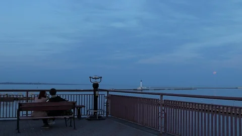 Couple at the sea station in the evening, man and woman at the sea station on Video stock 128449341