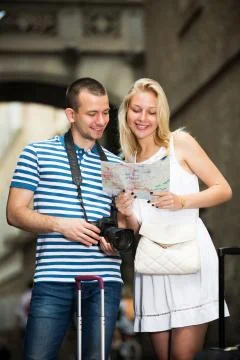 Couple searching direction using map Stock Photos