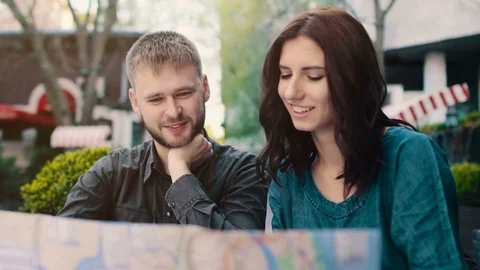 Couple searching on map in cafe. Stock Footage 74748316