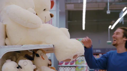 Couple Selecting Giant Teddy Bear as Gift Stock Footage 330953500