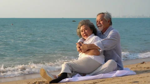 Couple senior sitting on the beach Stock Footage 183973908