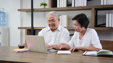 Couple senior is using laptop computer for watching online classes and webina Stock Footage 171257713