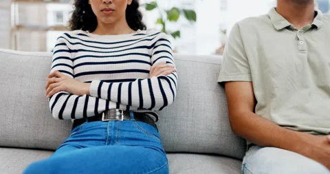 Couple, separation and conflict on sofa from disagreement fight or argument with Stock Footage 242078155