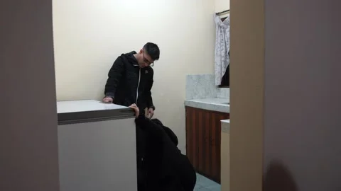 A couple setting up and turning on a freezer in a bungalow in a country house Stock Footage 161925008