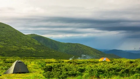 Couple Setting up Camp Tent in the Mountains Stock Footage 78422935