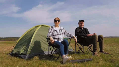 Couple setting up folding chairs at campsite Stock Footage 319788247