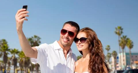 Couple in shades making selfie over venice beach Stock Photos