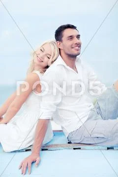 Couple in shades at sea side Stock Photos