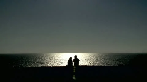 Couple Shadow next to Ocean 3 Stock Footage 10898389