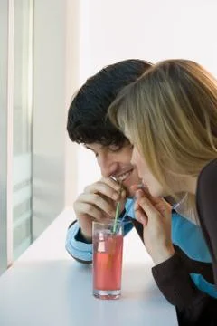 A couple sharing a drink Stock Photos
