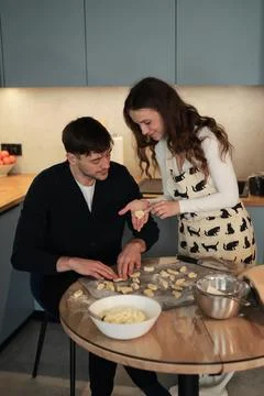 Couple Sharing Moment While Shaping Dumplings in Kitchen Stock-Fotos