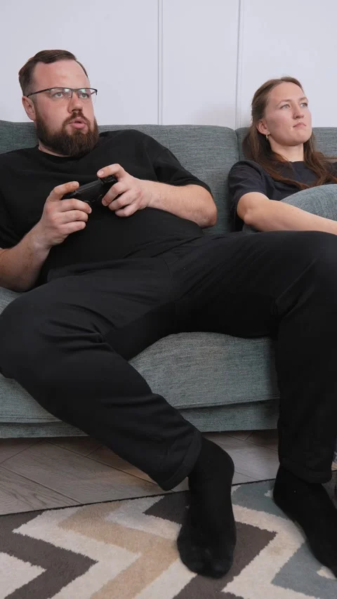 Couple sharing popcorn while watching movie on sofa Stock Footage 317444650