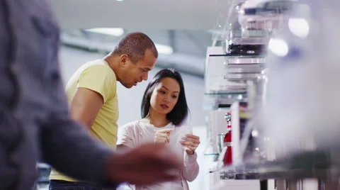 Couple shopping in a store selling kitchen appliances, white goods & electronics Stock Footage