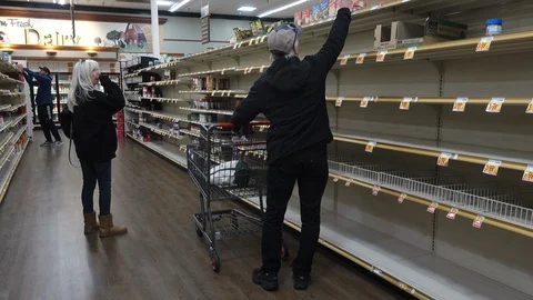 A couple shops the empty soup aisle at a grocery store Stock Footage
