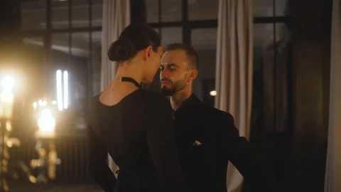 Couple showcasing passionate tango dance steps in a romantic setting. Stock Footage 284090288