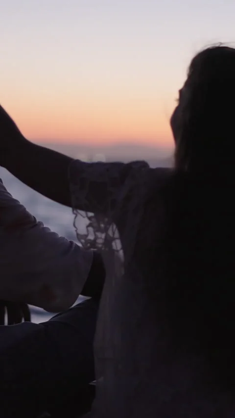 Couple shows affection for each other at a beautiful sunset Stock Footage 264915354