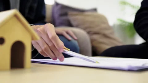Couple signing house contract document and receive key from agent real estate Stock Footage 260634256