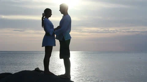 Couple silhouette at the beach. Sunset light. Stock Footage