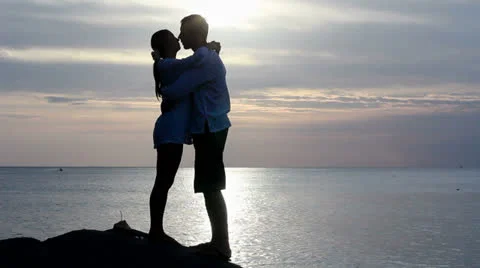 Couple silhouette at the beach. Sunset light. Stock Footage
