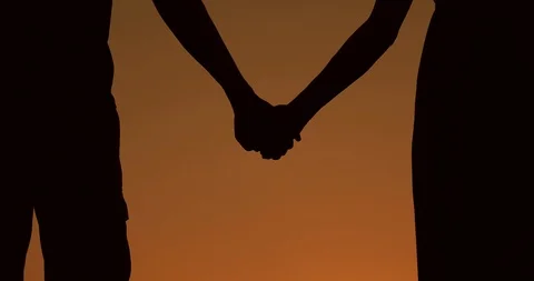 Couple silhouette holding hands. Love and relashionships. Stock Footage