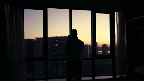 Couple Silhouette Standing by Window at Sunset 스톡 동영상 196239154