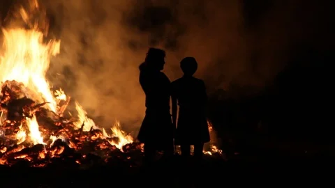 Couple silhouetted by fire Stock Footage 122725985