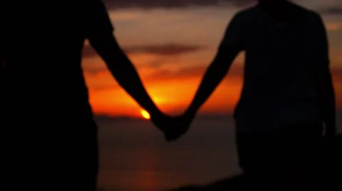 silhouette couple holding hands
