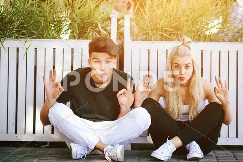 Couple sit and make faces Stock Photos