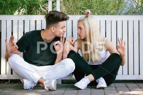 Couple sit and make faces Stock Photos