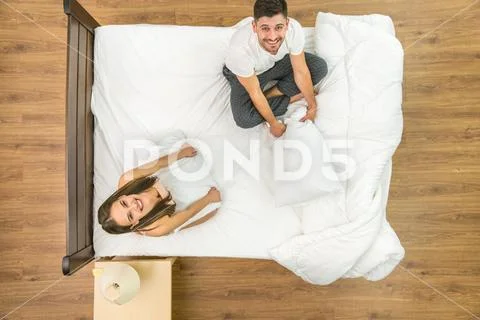 The couple sit on the bed. View from above Stock Photos