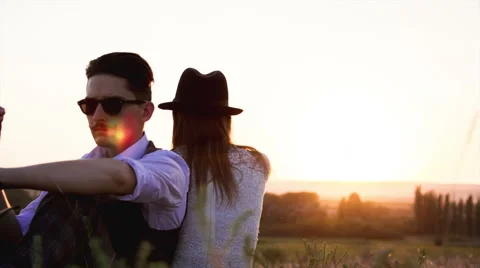 Couple sit on the grass and look and go Stock Footage 54662292
