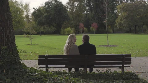 Couple Sit Talking On Park Bench | Stock Video | Pond5