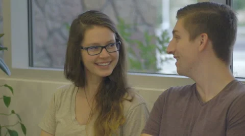 Couple Sits and Laughs Together Stock Footage 60989385