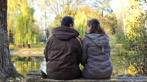Couple Sits In Park Stock Footage 8972721