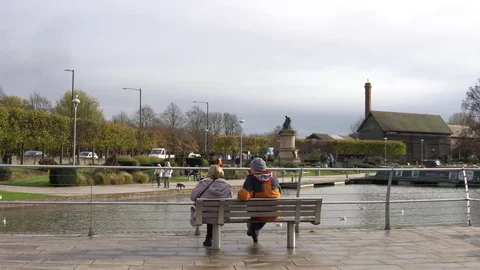 Couple sitting alone on the bench on the River Video stock 82842806