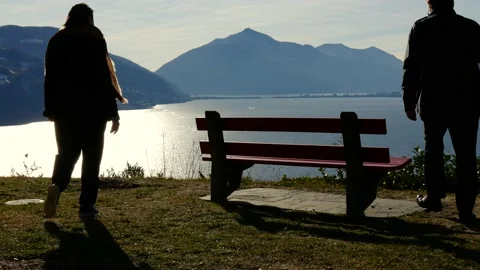 Couple Sitting and Hugging on a Bench with Mountain View in a Sunny Day Stock Footage 191953902
