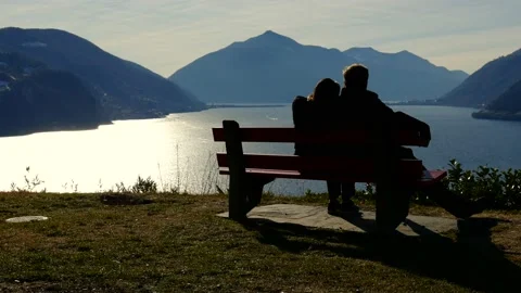 Couple Sitting and Hugging on a Bench with Mountain View Stock Footage 194011864