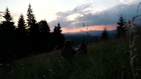 Couple sitting and hugging at sunset at mountains Stock Footage 159546385