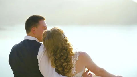 Couple Sitting and hugging on a top of the hill with Exotics Island and Sea View Stock Footage 221017594