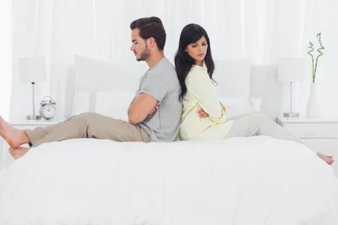 Couple sitting back to back during dispute Stock Photos