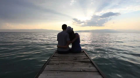 Couple sitting at the beach Stock Footage 35394579