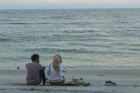 A couple sitting on the beach Stock Photos