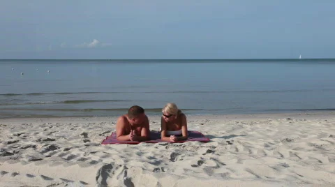 Couple sitting in the beach2 Stock Footage 715344